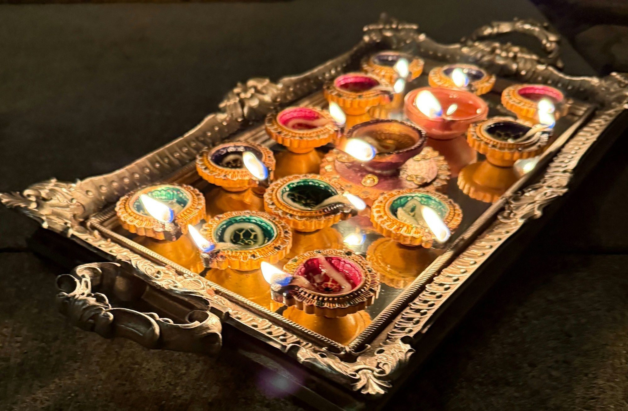 A tray of lit diyas